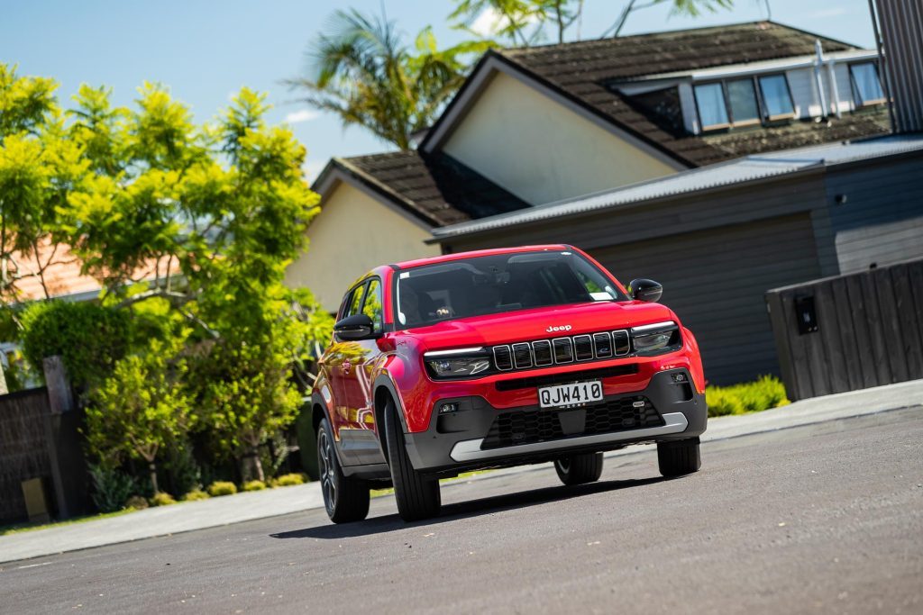 Taking a corner in a red Jeep Avenger 2024