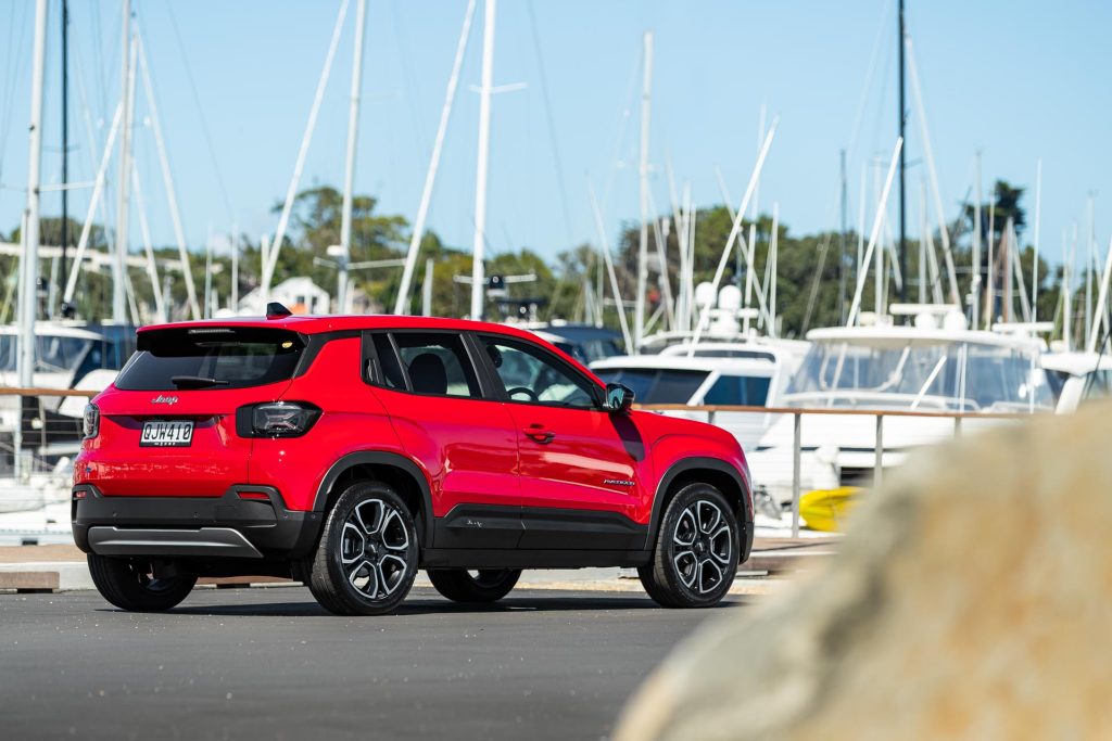 Jeep Avenger in red, parked at the Westhaven marina in Auckland