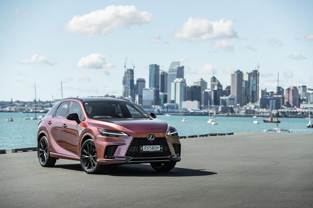 Lexus RX 500h front quarter in front of Auckland's city skyline