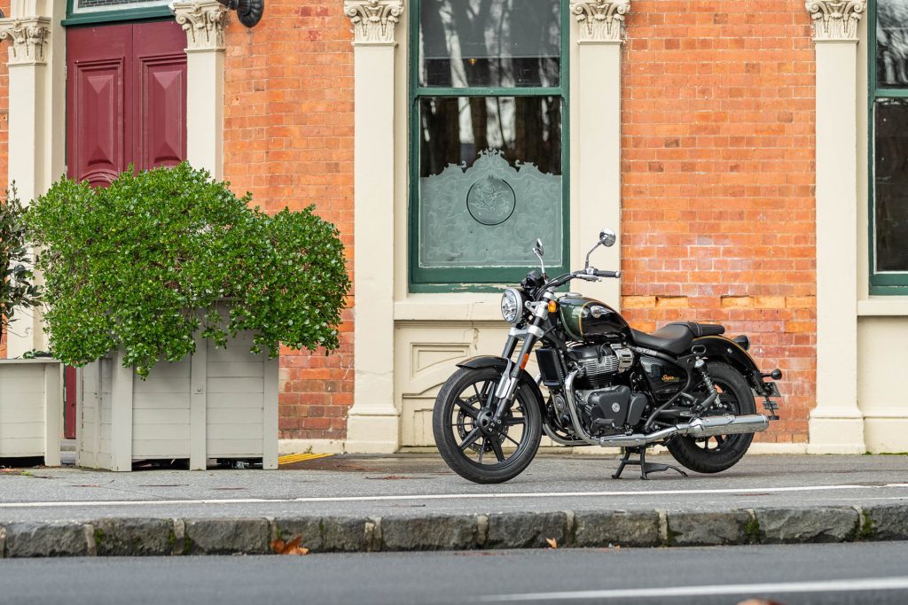 Royal Enfield Super Meteor 650 parked in front of a colonial style building