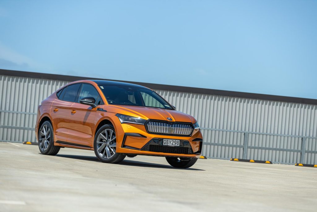 Skoda Enyaq 80 Coupe in orange, parked on a rooftop in the sun