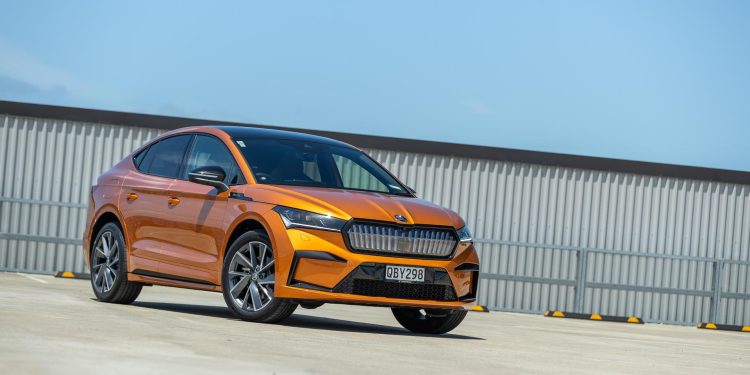 Skoda Enyaq 80 Coupe in orange, parked on a rooftop in the sun