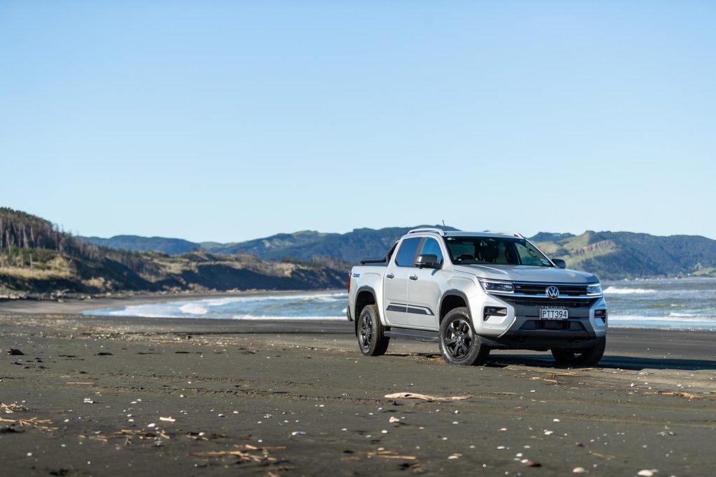 VW Amarok parked on Kariotahi beach, showing front quarter of ute