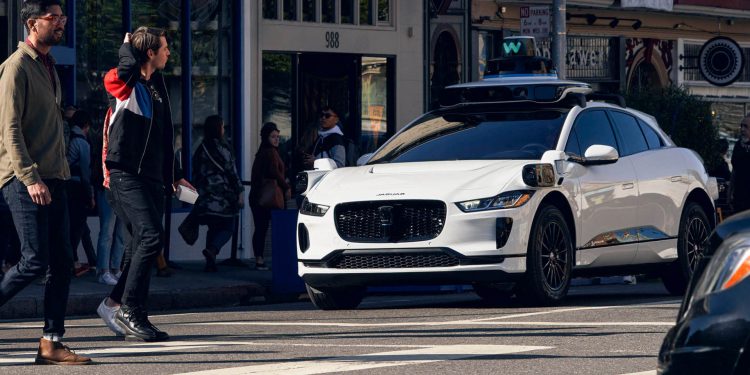Waymo Jaguar I-Pace driverless taxi stopped at pedestrian crossing