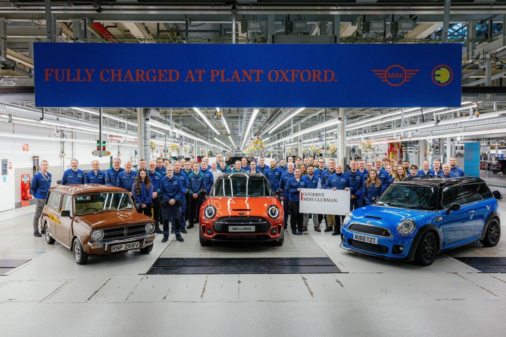 Workers surrounding three generations of Mini Clubman at Oxford plant