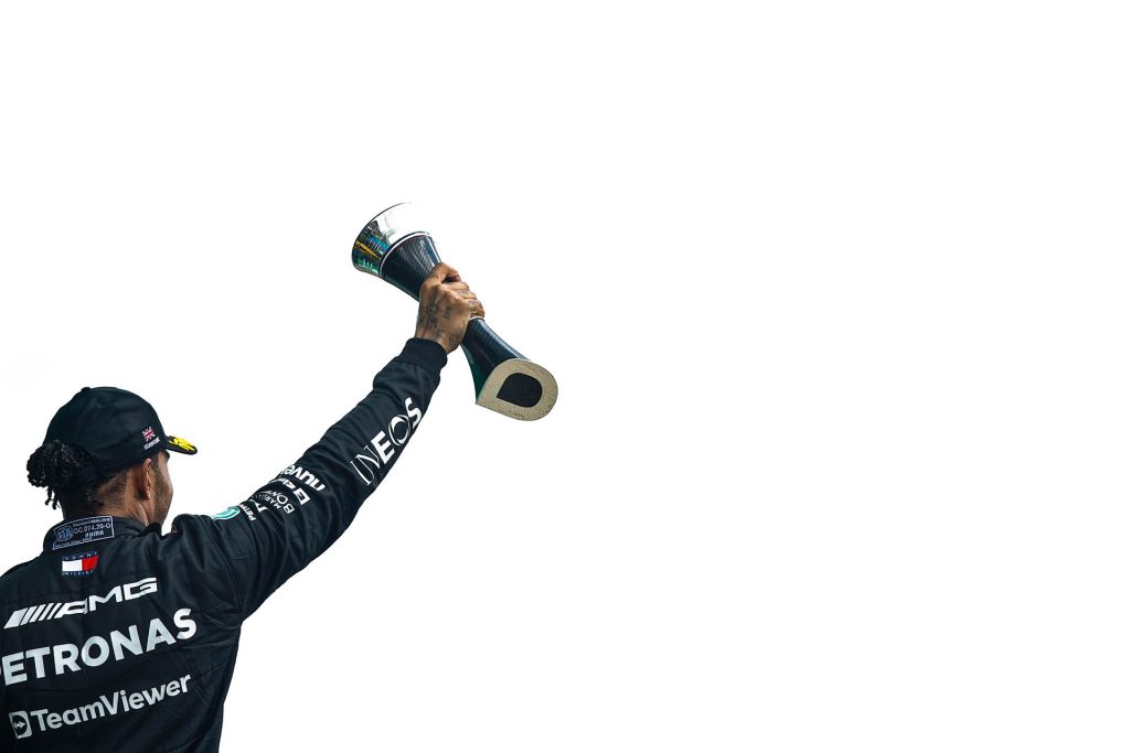 Lewis Hamilton holding trophy in the air