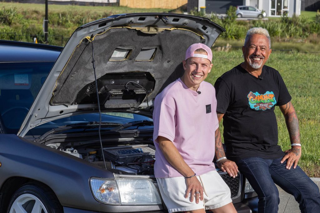 Liam Lawson standing with Mike King next to Subaru Forester charity project car