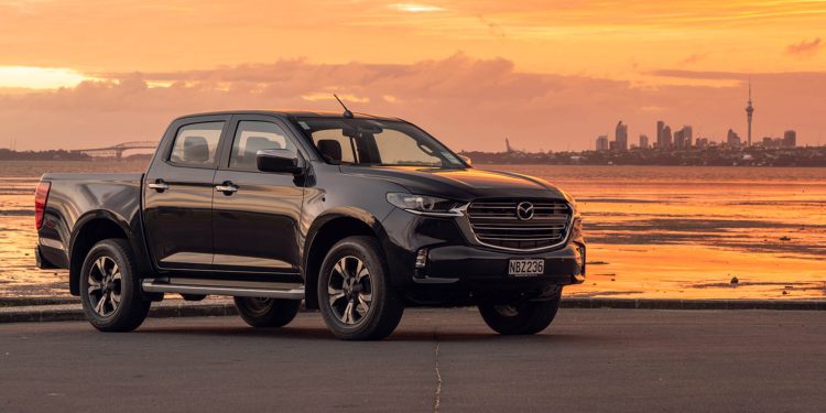 2020 Mazda BT-50 parked in front of Auckland city skyline at sunset