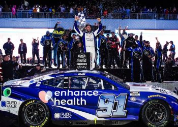 Shane van Gisbergen standing on NASCAR to celebrate Chicago Street Race win in 2023