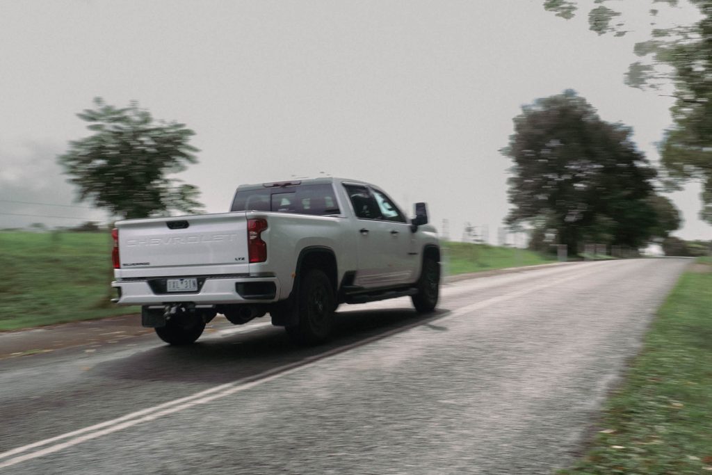 2024 Chevrolet Silverado 2500 HD rear three quarter view driving