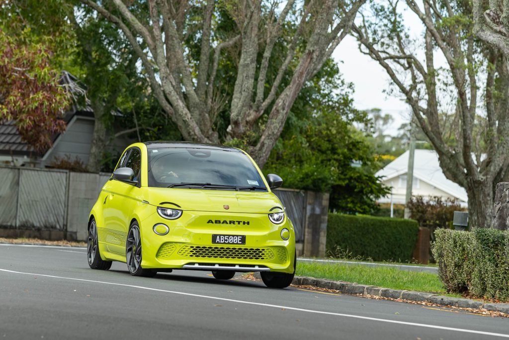 Abarth 500e Scorpionissima, in acid green, taking a corner