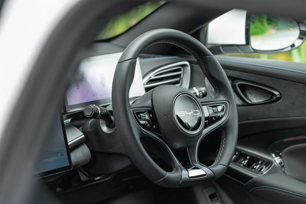 Steering wheel detail of the BYD Seal Dynamic with blue stitched interior