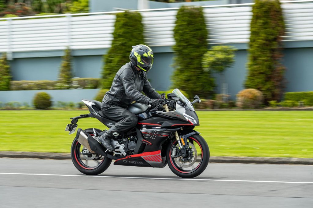 CFMoto 450 SR side profile panning shot while moving