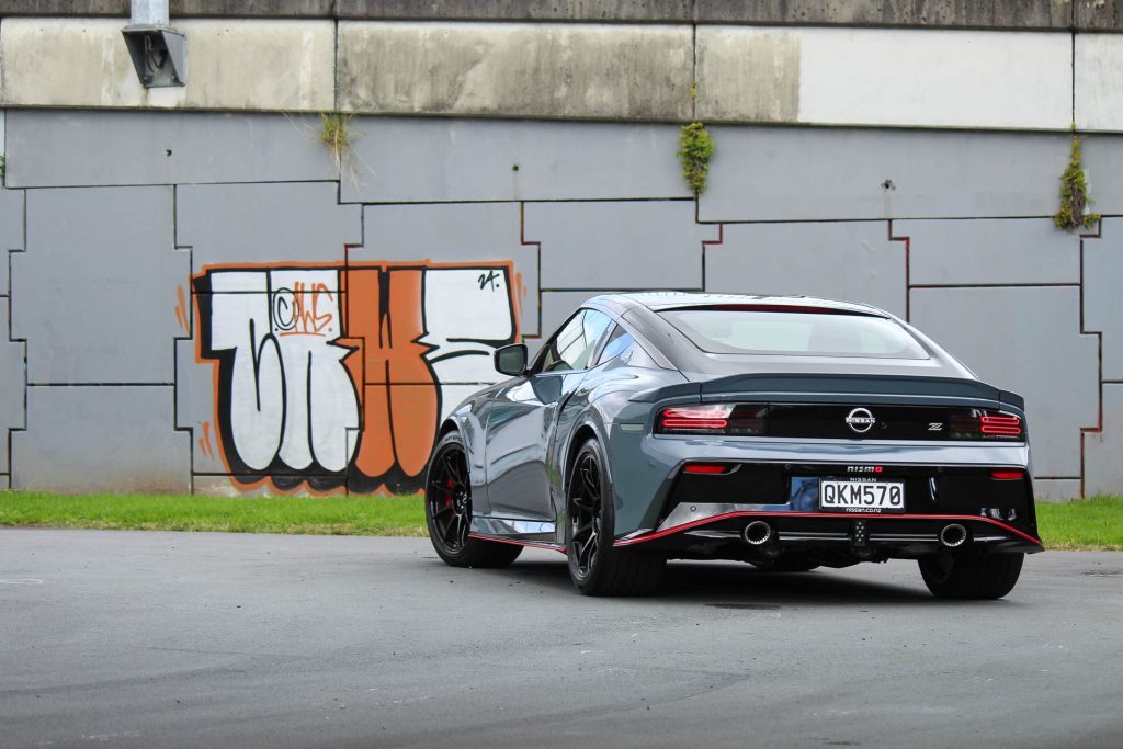 Nismo 400z rear view, parked next to graffiti