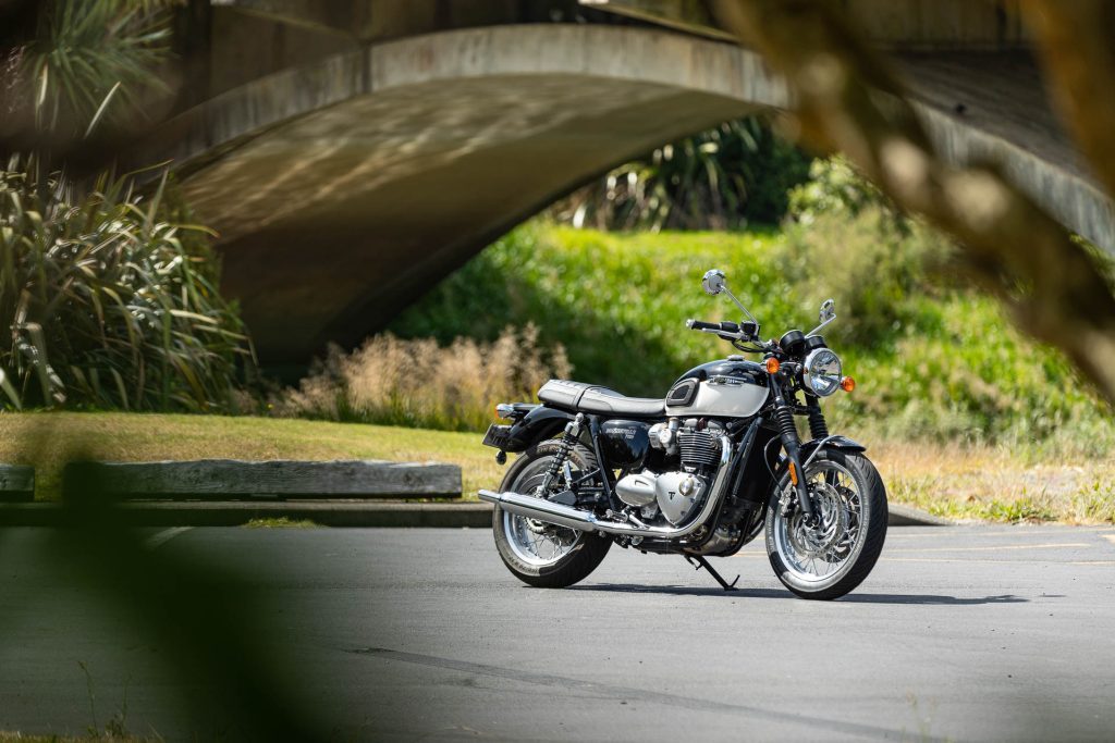 Triumph Bonneville T120, parked in front of a bridge