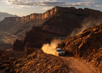 Defender Octa driving on dirt road