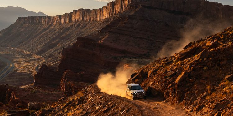 Defender Octa driving on dirt road