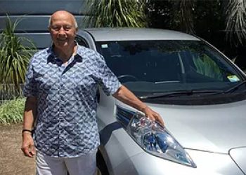 Vern Whitehead standing with Nissan Leaf