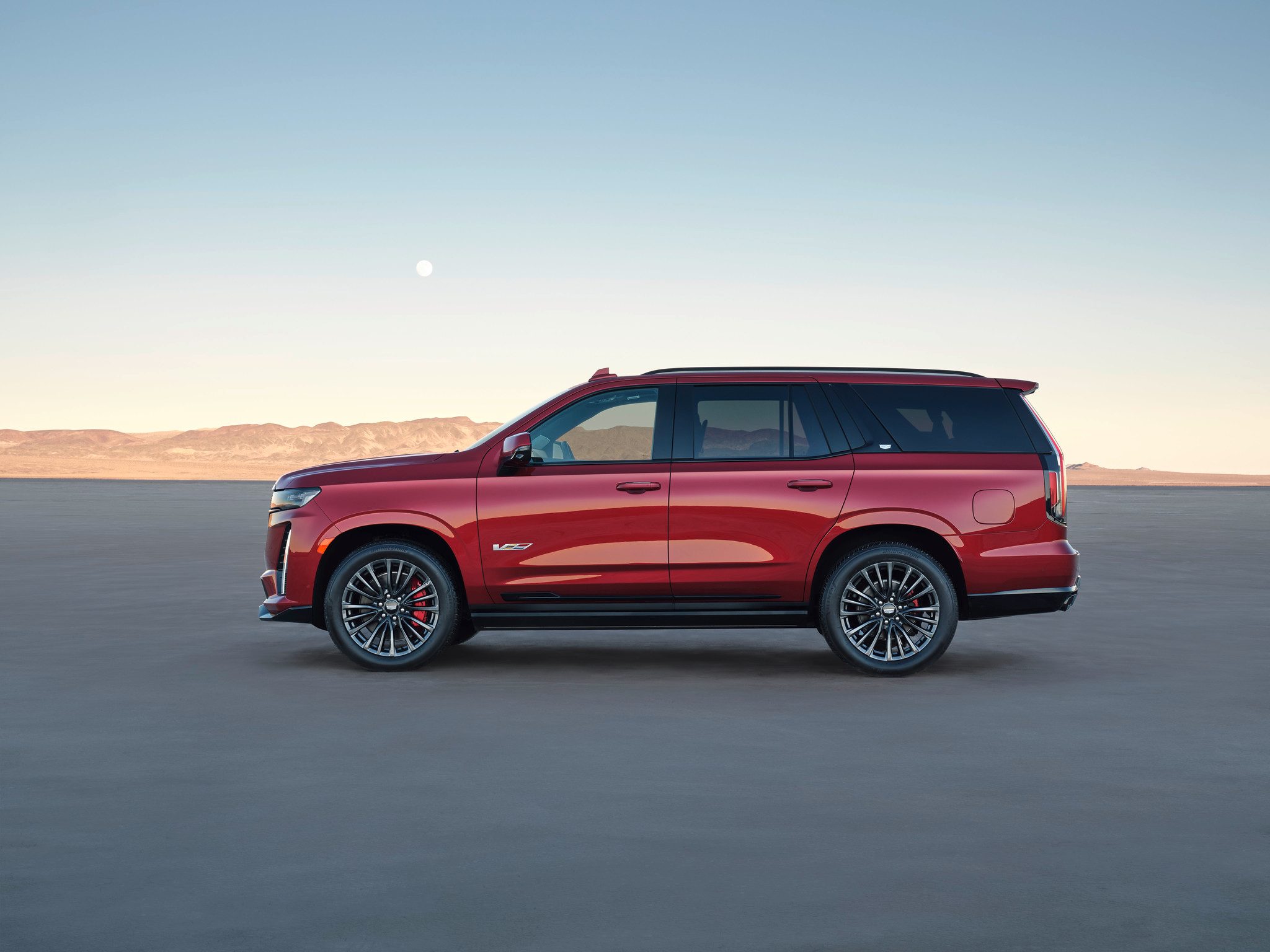 Large SUV in profile on salt pan.