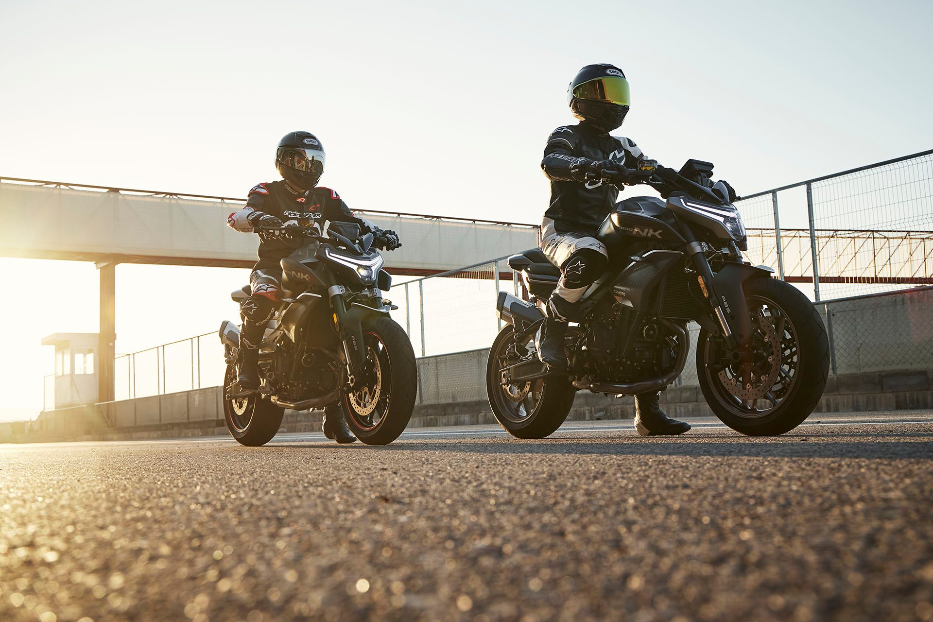 A pair of CFMoto 800NKs at a racetrack.