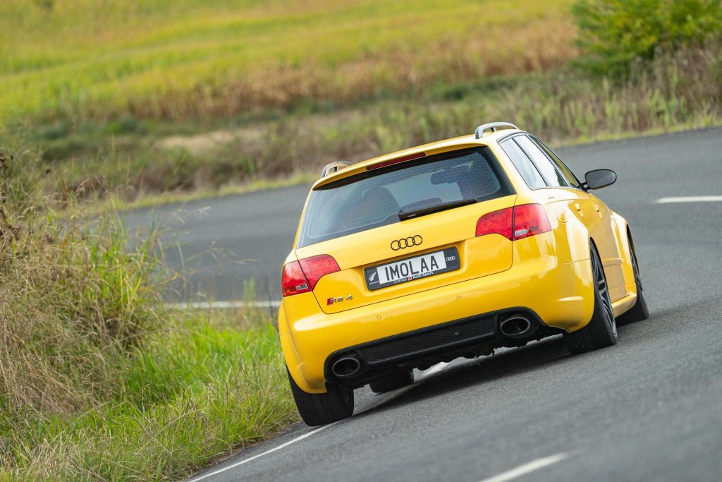 Audi RS4 B7 in yellow taking a corner at pace