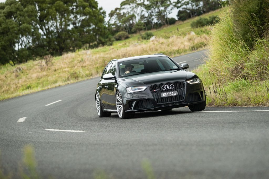 Audi RS4 B8 in black, taking a corner at pace