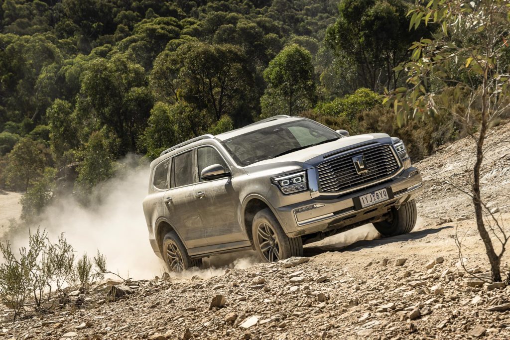 GWM Tank 500 Ultra  on a dirt track, moving with a dust cloud