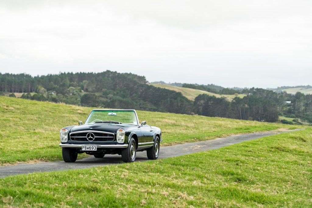 Mercedes-Benz 230 SL Pagoda front quarter shot, in the middle of a field