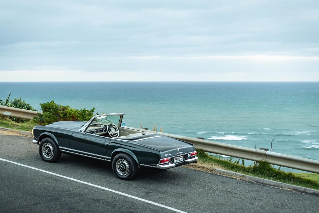 Mercedes-Benz 230 SL Pagoda scenic rear elevated shot, at Muriwai beach