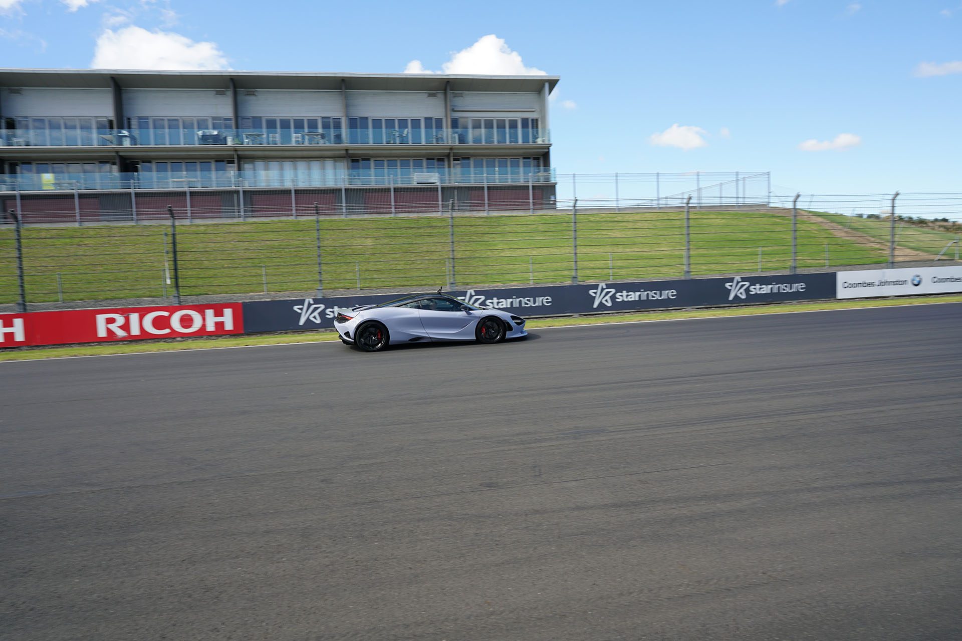 McLaren 750S at speed on track.