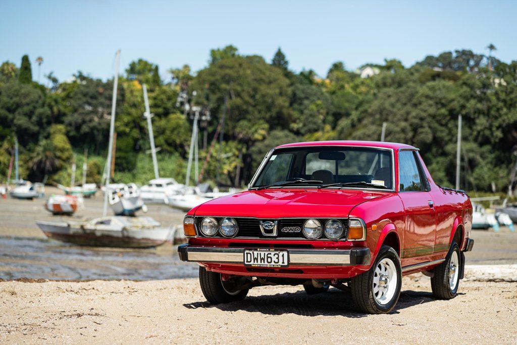 1981 Subaru Brumby in red, parked on a beach