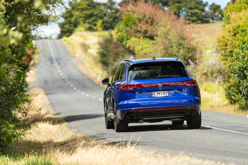 Exiting a corner, Volkswagen Touareg R PHEV shown in blue