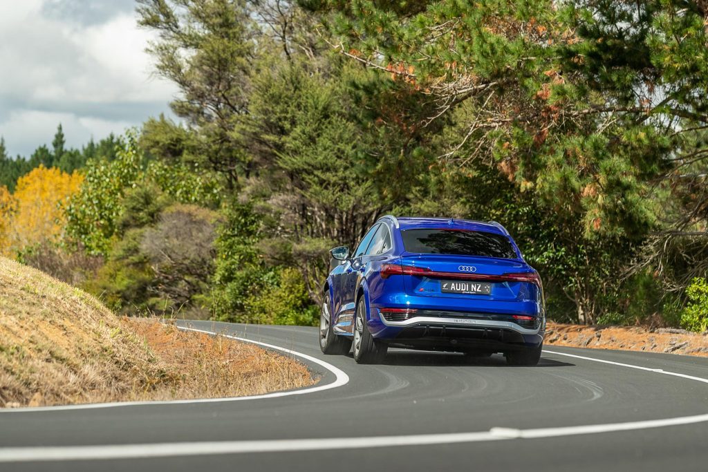 Rear cornering shot of the Audi SQ8 e-tron Sportback, on a backroad