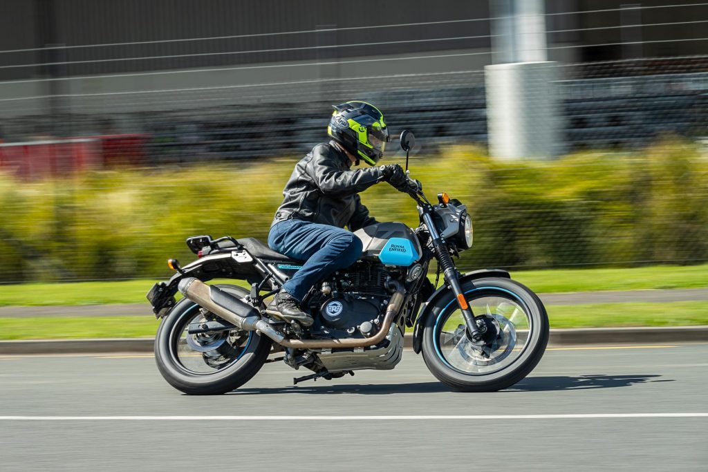 Royal Enfield Scram 411 leaning into a corner, panning shot