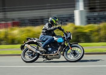 Royal Enfield Scram 411 leaning into a corner, panning shot