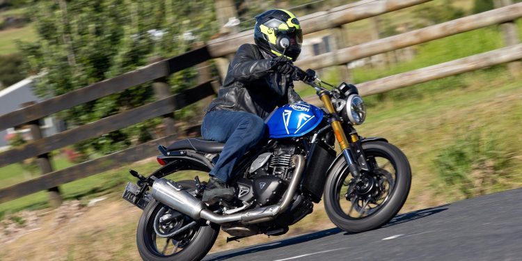 Triumph cornering at speed, blue
