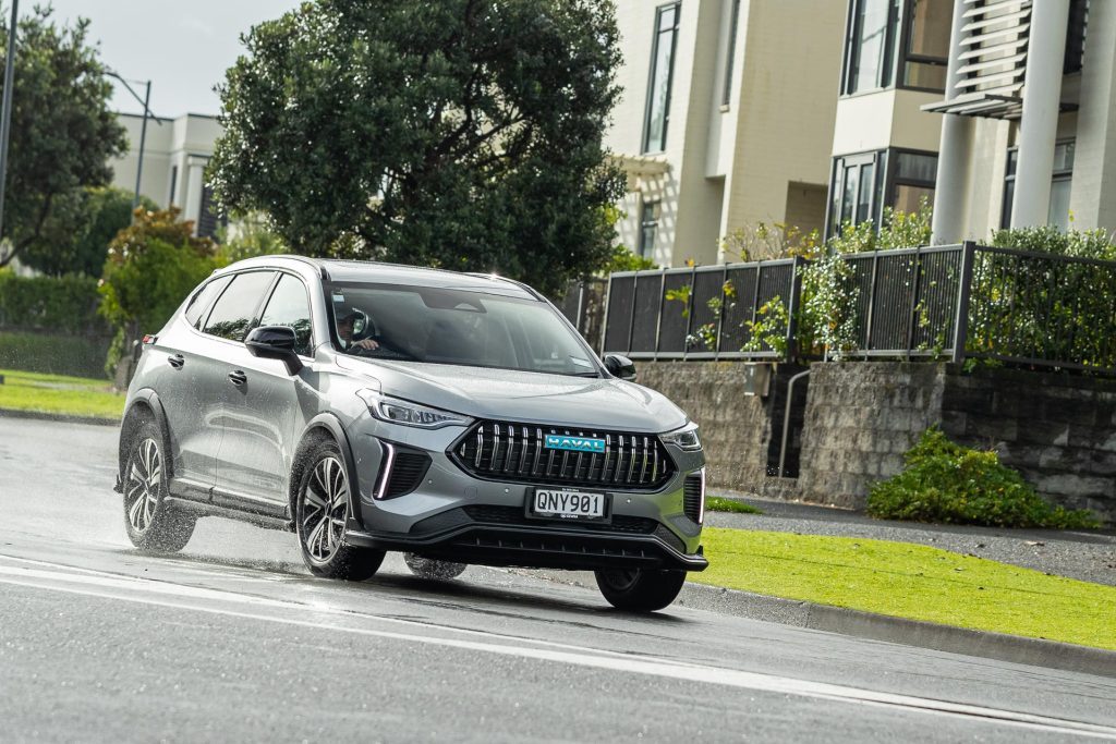 Haval Jolion Ultra Hybrid in grey, taking a corner in a suburban area