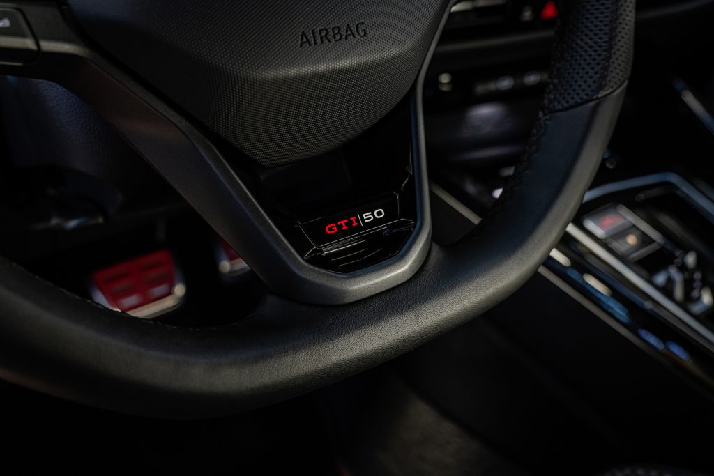 GTI 50 logo on the wheel, and scuff plates.