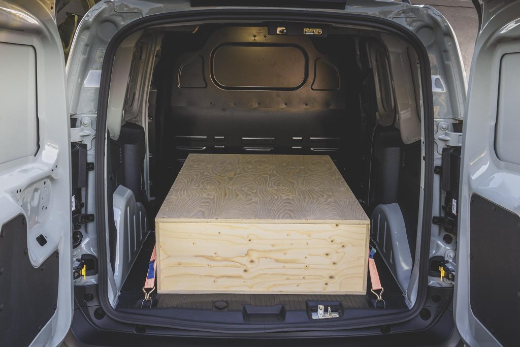 Big coffin in the back of Transit Courier.