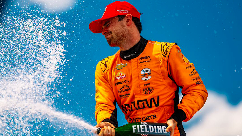 Pato O'Ward gets to spray the bubbles.