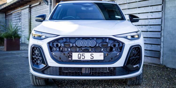 White Audi Q5 by a wooden barn