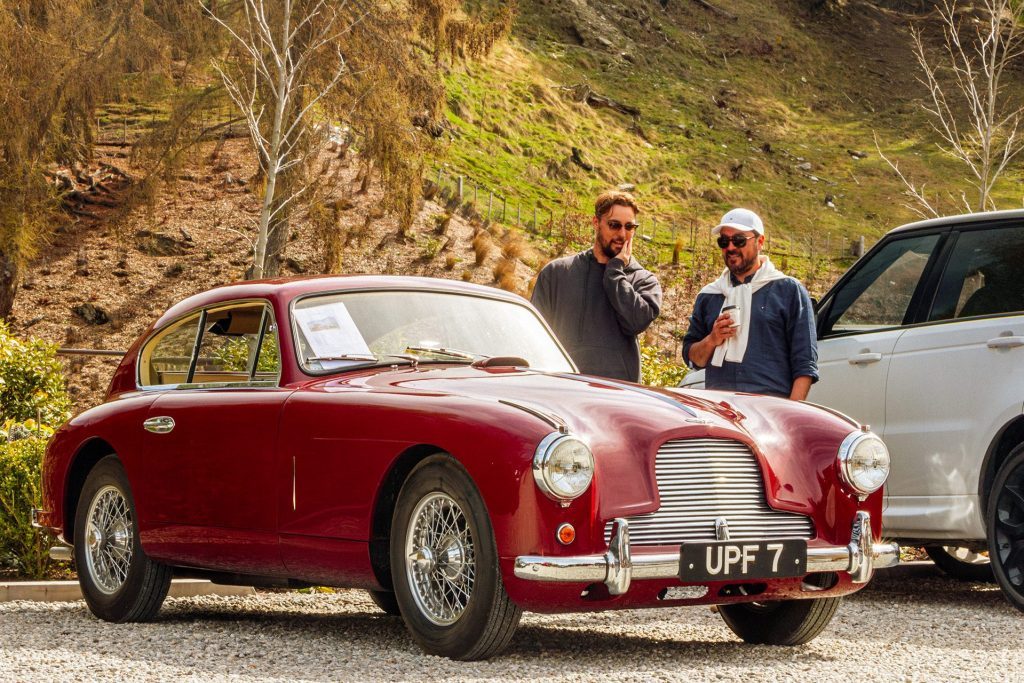 Guys ogling a classic Aston Martin.
