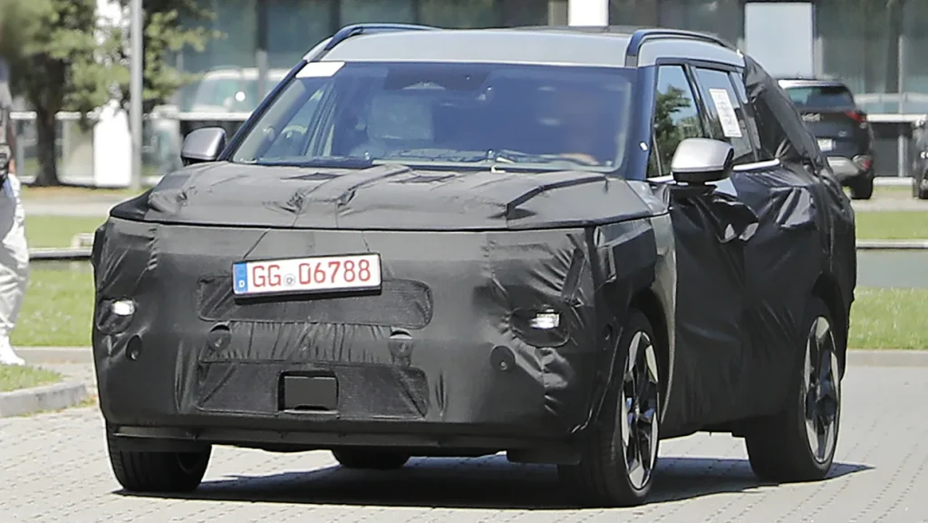 Upright DRLs and lower headlamp cluster are apparent beneath the covers.