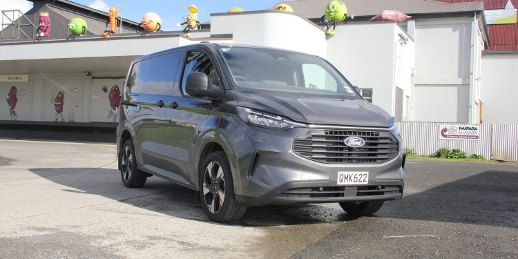 Grey Ford Transit Custom in front of white warehouse