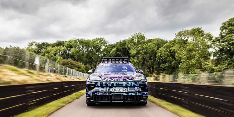 Porsche Cayenne EV on the start line with armco each side and trees behind