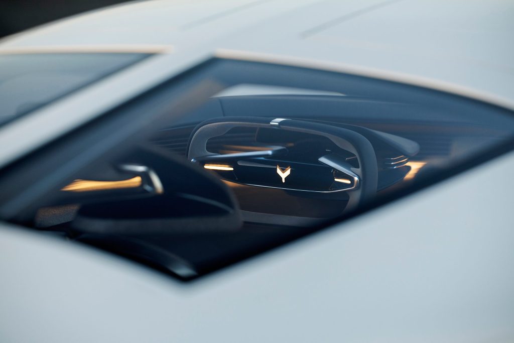 The interior of the electric Corvette, still with the oblong wheel, only more so in 2035.