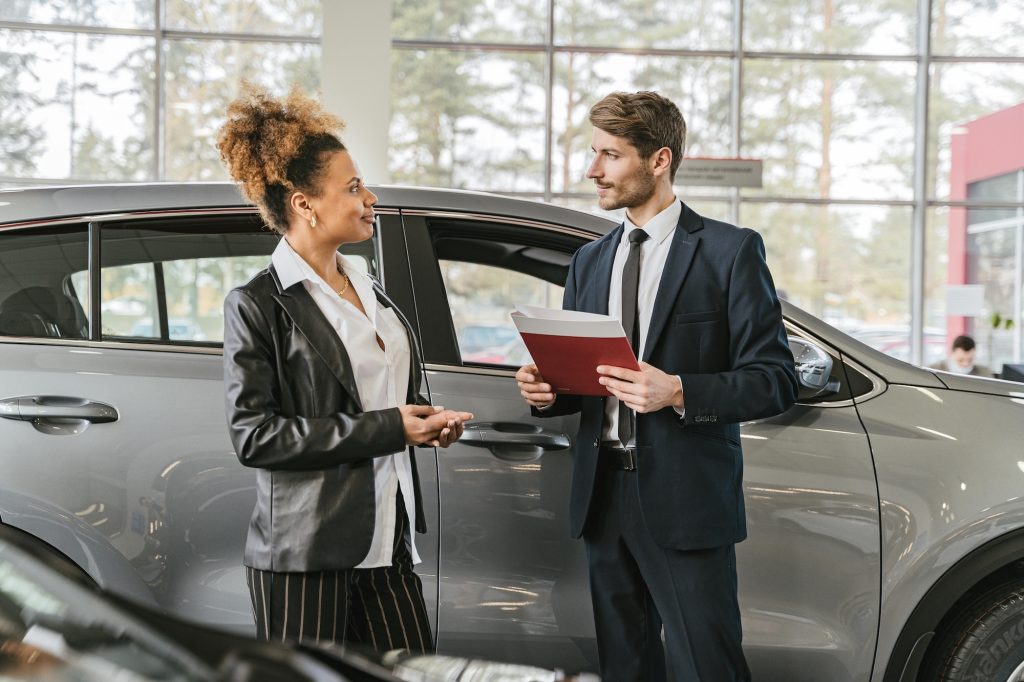 A male car salesman actually making eye contact with an actual woman.