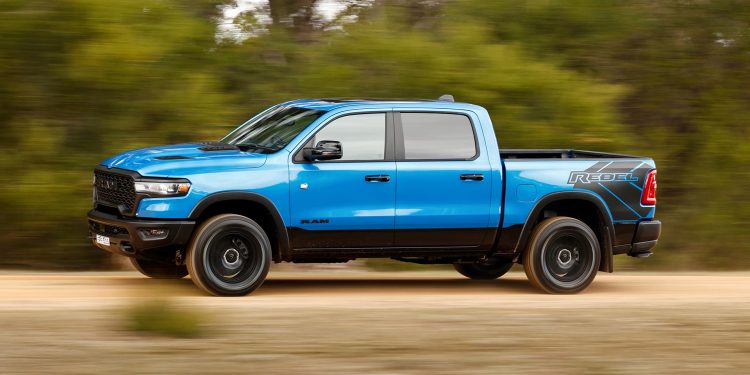 Ram 1500 Rebel in blue in the green bush