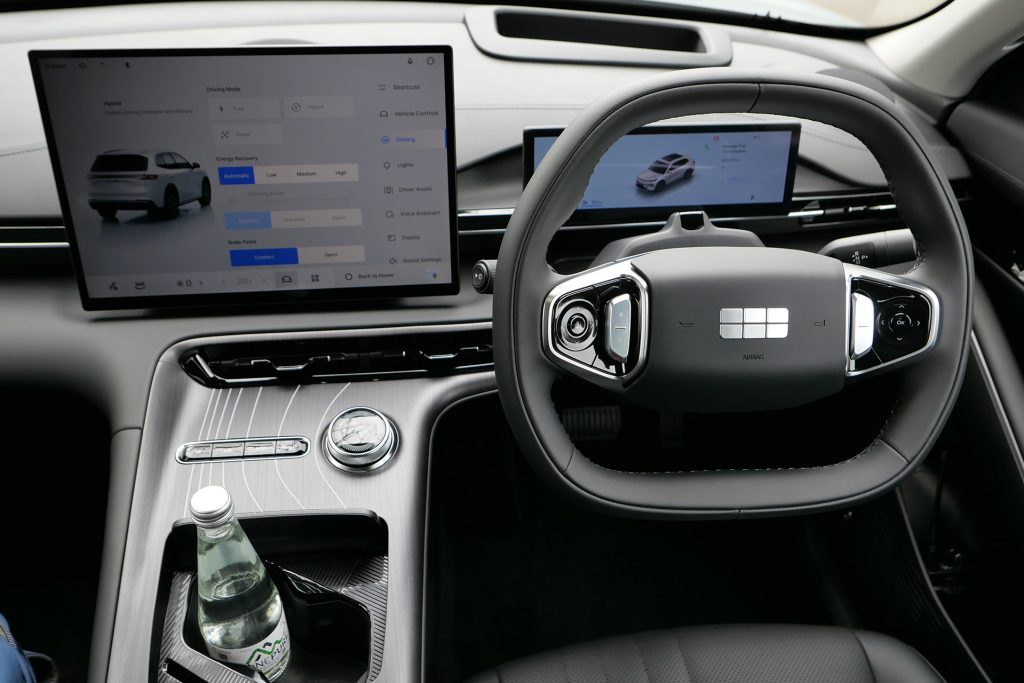 Interior of Starray showing its Geely six-cube badge on the eight-sided wheel.