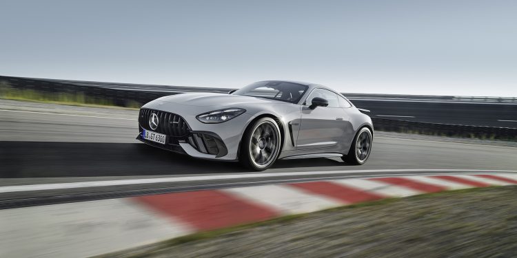 AMG GT on track with a red and white ripple strip in the foreground